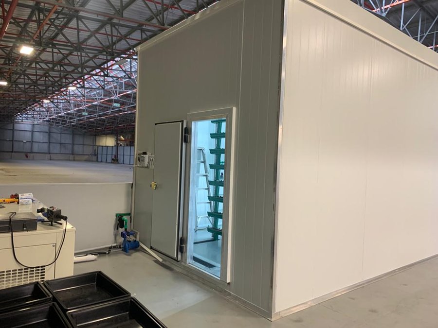 Controlled-environment agriculture grow room installed in a warehouse
